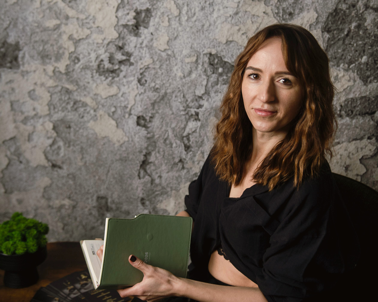 massage therapist holding notebook